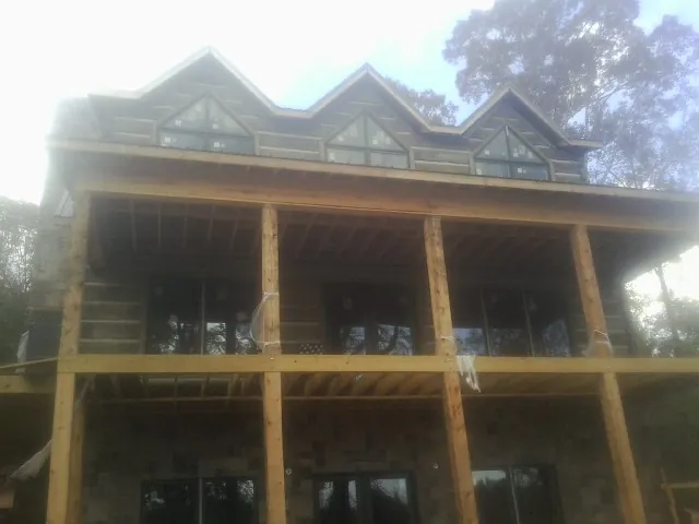 Dormers and porch framing on a large log home under construction in Odessa